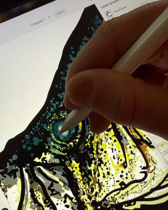 A close-up of a hand holding a white stylus and drawing on a tablet screen, creating a detailed graphic illustration with black, yellow, and teal colors.