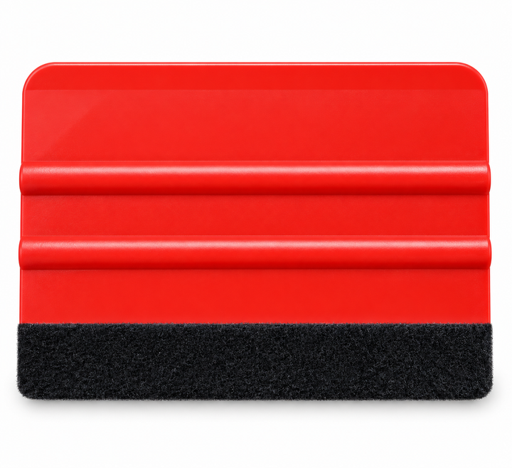 A red plastic squeegee with a black textured felt along the xa edge, shown on a plain white background.