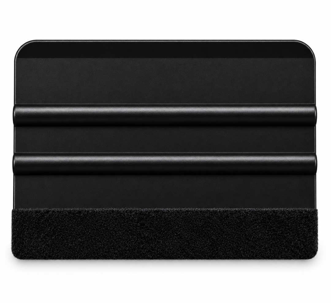 A black plastic squeegee with a black textured felt along the xa edge, shown on a plain white background.