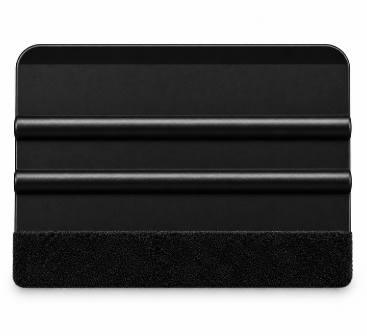 A black plastic squeegee with a black textured felt along the xa edge, shown on a plain white background.